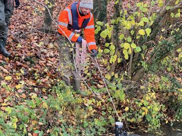 A technician uses an ADCP in the river