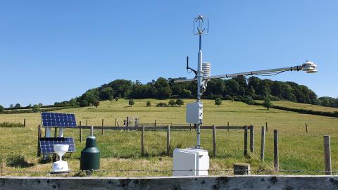 A COSMOS-UK monitoring site against a blue sky