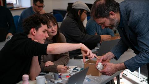 Participants in the workshop work together on assembling an open hardware sensor