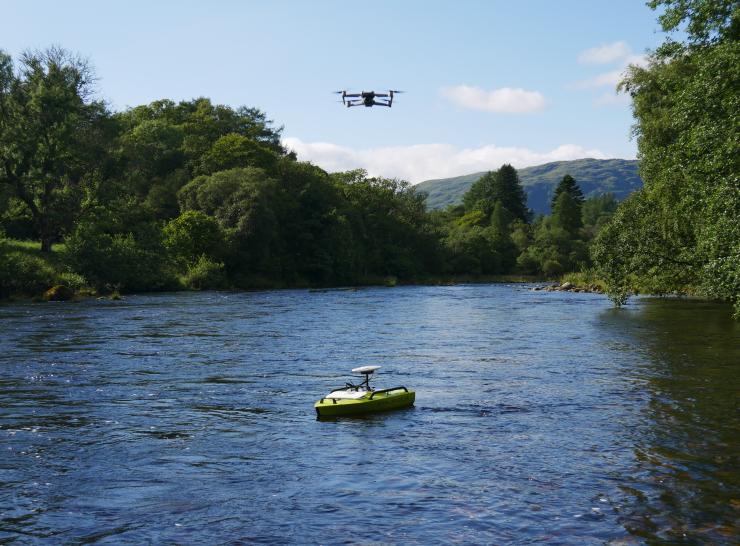 Arc boat on river and drone in the air