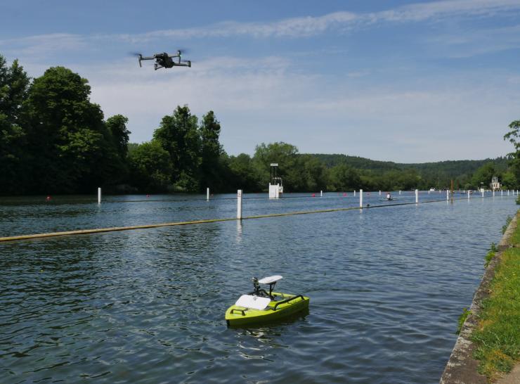 Image shows ARC boat on the River Thames, with a drone in the sky