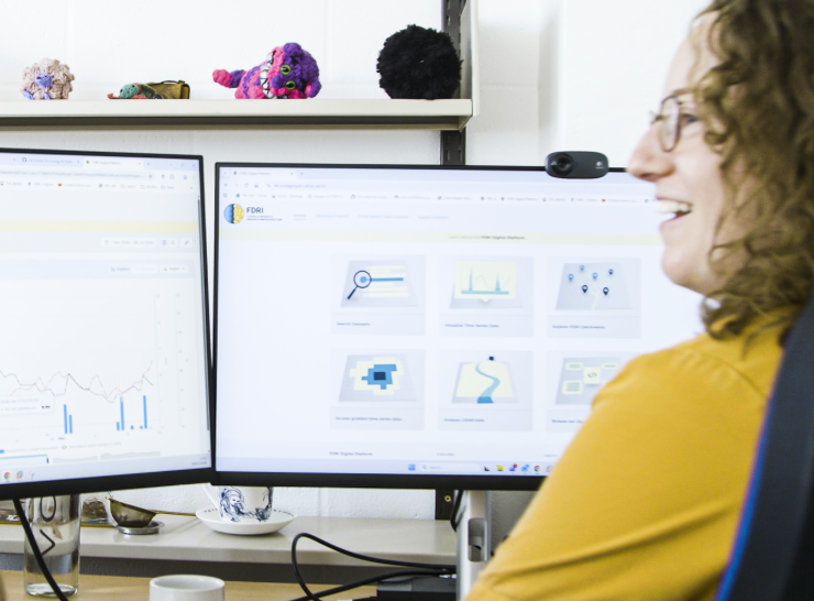 Users discuss the digital platform in front of screens